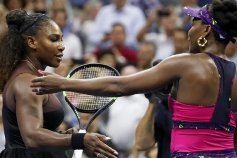 Serena Williams, left, meets her sister Venus Williams after their match during the third round of the U.S. Open tennis tournament, Friday, Aug. 31, 2018, in New York. Serena Williams won 6-1, 6-2. (AP Photo/Adam Hunger)