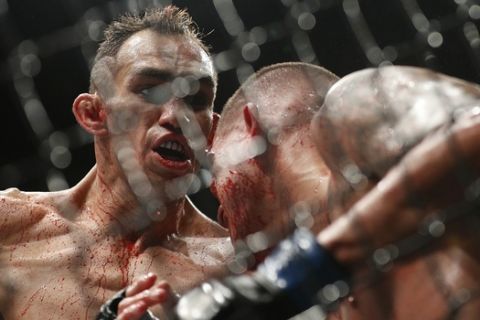 Tony Ferguson, left, fights Anthony Pettis during a lightweight mixed martial arts bout at UFC 229 in Las Vegas, Saturday, Oct. 6, 2018. (AP Photo/John Locher)