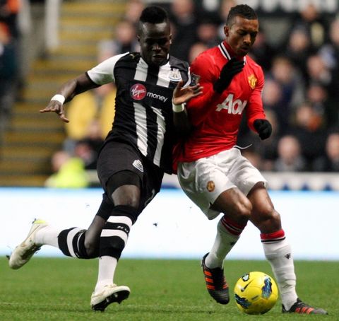 Newcastle United's Chiek Tiote, left, vies for the ball with Manchester United's Nani, right, during their English Premier League soccer match at the Sports Direct Arena, Newcastle, England, Wednesday, Jan. 4, 2012. (AP Photo/Scott Heppell)
