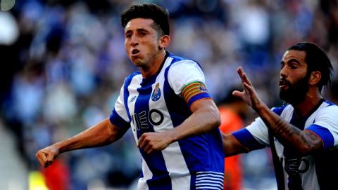 Porto's Porto's Hector Herrera celebrates with Porto's Sergio Oliveira, right, after scoring his side's first goal against Sporting in a Portuguese League soccer match at the Dragao stadium in Porto, Portugal, Saturday, April 30, 2016.(AP Photo/Paulo Duarte)