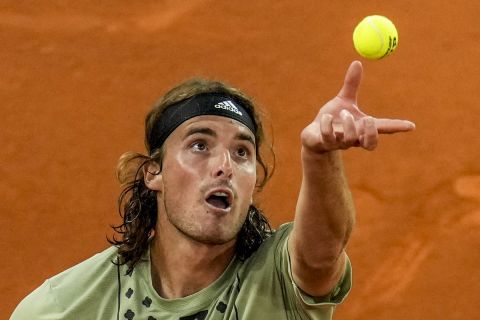 Greece's Stefanos Tsitsipas servers against Andrei Rubliov during their match at the Mutua Madrid Open tennis tournament in Madrid, Spain, Friday, May 6, 2022. (AP Photo/Manu Fernandez)
