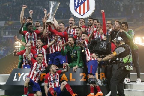 Atletico players celebrate with the trophy after winning the Europa League Final soccer match between Marseille and Atletico Madrid at the Stade de Lyon in Decines, outside Lyon, France, Wednesday, May 16, 2018. (AP Photo/Thibault Camus)