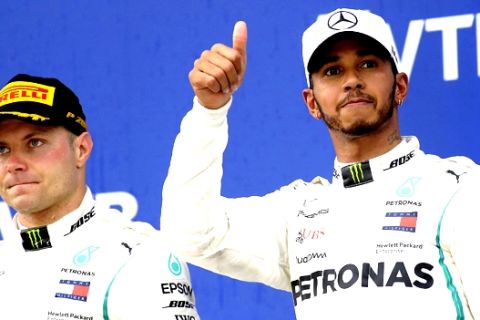 Mercedes driver Valtteri Bottas of Finland, left, and Mercedes driver Lewis Hamilton of Britain celebrate after the Russian Formula One Grand Prix at the Sochi Autodrom circuit in Sochi, Russia, Sunday, Sept. 30, 2018.(AP Photo/Sergei Grits)