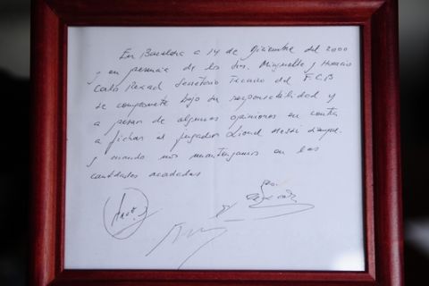 In this photo taken, Thursday, Jan. 5, 2012,  a framed copy of the napkin linking a 13-year-old Lionel Messi to FC Barcelona is seen in Barcelona, Spain. The club's technical secretary and past coach Carles Rexach scribbled out an informal contract on a napkin, the closest piece of paper he could find at Barcelona's Pompei Tennis Club. The small napkin reads: "In Barcelona, on the 14th of December of 2000 and in the presence of Josep Minguella and Horacio (Gaggioli), Carles Rexach, F.C.B technical secretary, it commits under his responsibility and despite some views against it to sign the player Lionel Messi, as long we stick to amounts agreed upon."(AP Photo/Manu Fernandez)