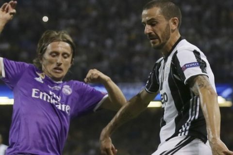 Real Madrid's Luka Modric, left, challenges for the ball with Juventus' Leonardo Bonucci during the Champions League final soccer match between Juventus and Real Madrid at the Millennium Stadium in Cardiff, Wales, Saturday June 3, 2017. (AP Photo/Tim Ireland)