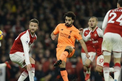 Liverpool's Mohamed Salah shoots and scores his sides 2nd goal of the game during their English Premier League soccer match between Arsenal and Liverpool at the Emirates stadium London, Friday, Dec. 22, 2017. (AP Photo/Alastair Grant)