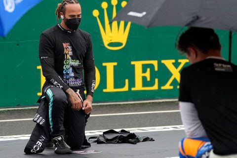 Mercedes driver Lewis Hamilton of Britain takes a knee in support of the Black Lives Matter movement before the Hungarian Formula One Grand Prix at the Hungaroring racetrack in Mogyorod, Hungary, Sunday, Aug. 1, 2021. (AP Photo/Darko Bandic)