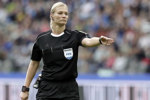 FILE - In this Sept. 10, 2017 file photo, Referee Bibiana Steinhaus points during the German Bundesliga soccer match between Hertha BSC Berlin and SV Werder Bremen in Berlin, Germany. Bibiana Steinhaus, is the first female referee to officiate in the Bundesliga. (AP Photo/Michael Sohn,file)