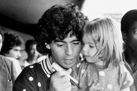World famous soccer star Diego Maradona signs autographs with his two year old daughter Dalma Nerea after arriving in Rio's Galaeo International Airport in Rio de Janeiro, June 30, 1989. The famed striker, who led Italy's Napoli club to the UEFA Cup title and is widely considered by experts to be the best player in the world, joined the Argentine national soccer team as it prepared for the first round of the continent-wide America Cup tournament. (AP Photo/Marco Teixeira)