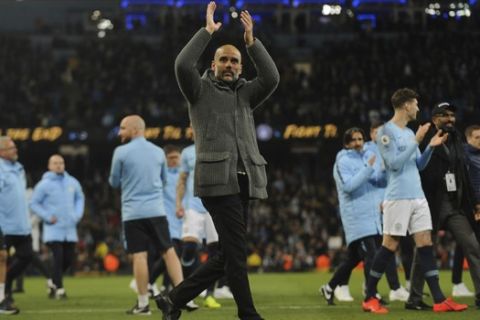 Manchester City manager Pep Guardiola greets supporters at the end of the English Premier League soccer match between Manchester City and Leicester City at the Etihad stadium in Manchester, England, Monday, May 6, 2019. (AP Photo/Rui Vieira)