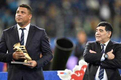 Soccer legend Ronaldo holds the best scorer award as Diego Maradona looks on after Germany won 1-0 in the Confederations Cup final soccer match between Chile and Germany, at the St.Petersburg Stadium, Russia, Sunday July 2, 2017. (AP Photo/Martin Meissner)