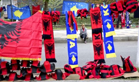 A street vendor selling Kosovo and Albania flags waits for customers, prior to the World Cup Group I qualifying match near the Loro Boric Stadium in Shkoder, Albania, Thursday Oct. 6, 2016. (AP Photo/Visar Kryeziu) 