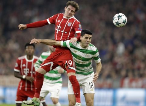 Bayern's Sebastian Rudy, left, and Celtic's Tom Rogic challenge for the ball during a Group B Champions League soccer match between Bayern Munich and Celtic F.C. at the Allianz Arena in Munich, Germany, Wednesday, Oct. 18, 2017. (AP Photo/Matthias Schrader)