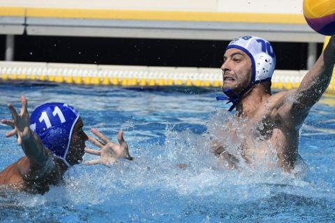 Filip Filipovic, of Serbia, prepares, right, to throw the ball past Alexandros Gounas, of Greece, during the men's water polo Group C third round match of the 17th FINA Swimming World Championships in Hajos Alfred National Swimming Pool in Budapest, Hungary, Friday, July 21, 2017. (Balazs Czagany/MTI via AP)