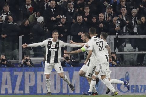 Juventus' Cristiano Ronaldo, left, celebrates after scoring his side's second goal during the Champions League round of 16, 2nd leg, soccer match between Juventus and Atletico Madrid at the Allianz stadium in Turin, Italy, Tuesday, March 12, 2019. (AP Photo/Luca Bruno)