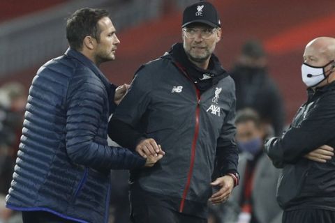 Chelsea's head coach Frank Lampard, left shakes hands with Liverpool's manager Jurgen Klopp after the end of the English Premier League soccer match between Liverpool and Chelsea at Anfield Stadium in Liverpool, England, Wednesday, July 22, 2020. Liverpool won the game 5-3. (Phil Noble/Pool via AP)