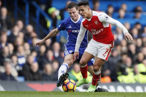 Arsenal's Alexis Sanchez, right holds off the challenge of Chelsea's Cesar Azpilicueta during the English Premier League soccer match between Chelsea and Arsenal at Stamford Bridge stadium in London, Saturday, Feb. 4, 2017. (AP Photo/Kirsty Wigglesworth)