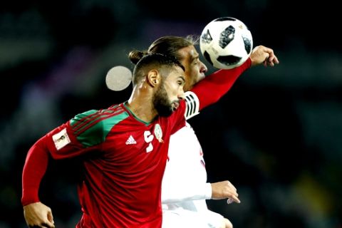 Morocco's Medhi Benatia, left, jumps for the ball with Serbia's Aleksander Prijovic during a friendly soccer match between Serbia and Morocco in Turin, Italy, Friday, March 23, 2018. (AP Photo/Antonio Calanni)