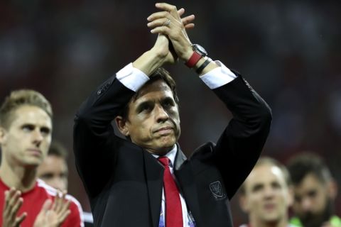 FILE - In this Wednesday, July 6, 2016 file photo, Wales coach Chris Coleman acknowledges the fans at the end of their Euro 2016 semifinal soccer match against Portugal at the Grand Stade in Decines-­Charpieu, France. Five straight draws in qualifying for the 2018 World Cup, including one at home to Georgia, left the Welsh fearing theyd be watching the tournament on TV. With no margin for error, Wales has steadied the campaign with wins over Austria and Moldova but Bale and his teammates have a defining week ahead of them: Georgia away on Friday, Oct. 6, 2017 and then a group-ending home match against Ireland on Monday. Realistically, Wales coach Chris Coleman has said, we have to get maximum (points) to give ourselves a chance of second. (AP Photo/Thanassis Stavrakis, file)