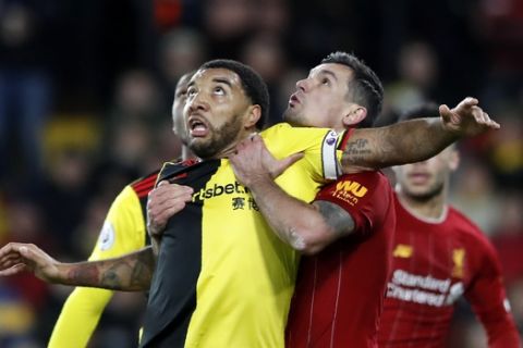 Watford's Troy Deeney, front left, duels for the ball with Liverpool's Dejan Lovren during the English Premier League soccer match between Watford and Liverpool at Vicarage Road stadium, in Watford, England, Saturday, Feb. 29, 2020. (AP Photo/Alastair Grant)