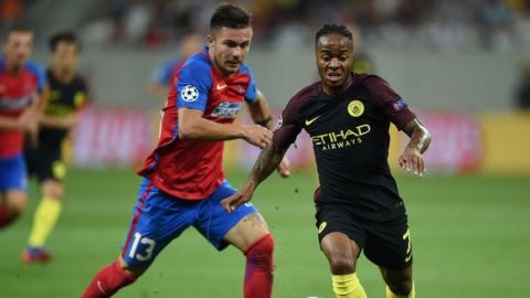 Manchester City's English midfielder Raheem Sterling (R) vies for the ball with Steaua Bucharest's Romanian defender Alin Tosca during the UEFA Champions league first leg play-off football match between Steaua Bucharest and Manchester City at the National Arena stadium in Bucharest on August 16, 2016.  / AFP / DANIEL MIHAILESCU        (Photo credit should read DANIEL MIHAILESCU/AFP/Getty Images)