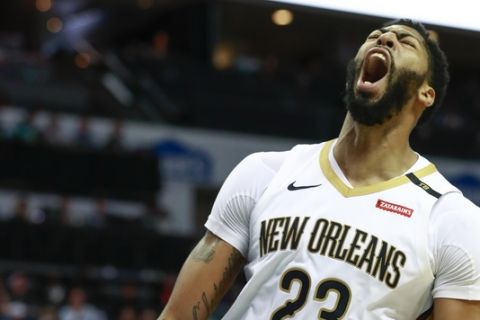 New Orleans Pelicans center Anthony Davis reacts after dunking the ball while facing the Charlotte Hornets in the second half of an NBA basketball game Sunday, Dec. 2, 2018, in Charlotte, N.C. New Orleans won 119 to 109. (AP Photo/Jason E. Miczek)