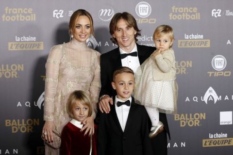 Real Madrid's Luka Modric arrives with his family for the Golden Ball, "Ballon d'Or" award ceremony at the Grand Palais in Paris, France, Monday, Dec.3, 2018. Awarded every year by France Football magazine since Stanley Matthews won it in 1956, the Ballon d'Or, Golden Ball for the best player of the year will be given to both a woman and a man. (AP Photo/Christophe Ena)