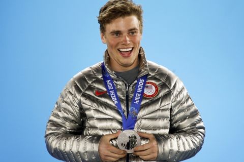 Silver medalist Gus Kenworthy of the U.S. celebrates during the medal ceremony of the men's freestyle skiing slopestyle finals at the 2014 Sochi Winter Olympics, February 13, 2014.  REUTERS/Eric Gaillard (RUSSIA  - Tags: SPORT OLYMPICS SPORT SKIING)   - RTX18RAF