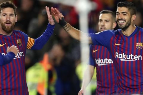 FC Barcelona's Luis Suarez, right, celebrates after scoring his opening goal with his teammate Lionel Messi during the Spanish La Liga soccer match between FC Barcelona and Eibar at the Camp Nou stadium in Barcelona, Spain, Sunday, Jan. 13, 2019. (AP Photo/Manu Fernandez)