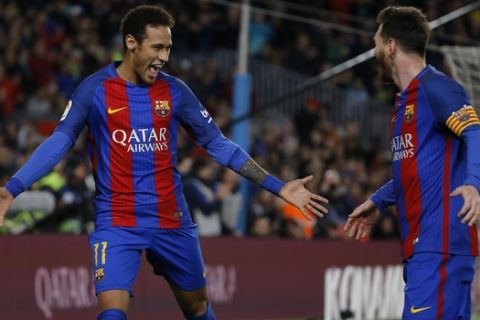 Barcelona's Neymar, left, celebrates with teammate Lionel Messi after scoring their side's second goal against Celta during a Spanish La Liga soccer match between Barcelona and Celta at the Camp Nou stadium in Barcelona, Saturday, March 4, 2017. (AP Photo/Francisco Seco)
