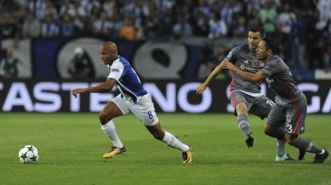 Porto's Yacine Brahimi, left, runs with the ball during the Champions League group G soccer match between FC Porto and Besiktas at the Dragao stadium in Porto, Portugal, Wednesday, Sept. 13, 2017. (AP Photo/Paulo Duarte)