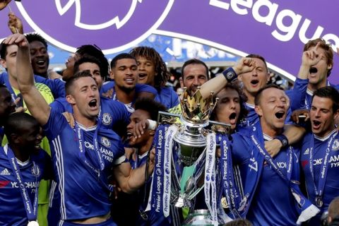Chelsea captain John Terry, right, and Gary Cahill raise the trophy after they won the league, following the English Premier League soccer match between Chelsea and Sunderland at Stamford Bridge stadium in London, Sunday, May 21, 2017. (AP Photo/Frank Augstein)