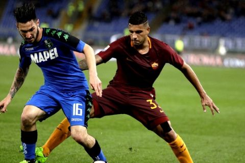 Sassuolo's Matteo Politano, left, and Roma's Emerson compete for the ball during a Serie A soccer match between Roma and Sassuolo, at the Olympic stadium in Rome, Sunday, March 19, 2017. (AP Photo/Andrew Medichini)