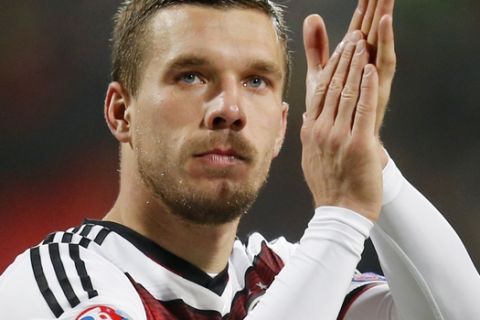 FILE - In this Nov. 14, 2014 file picture Germany's Lukas Podolski applauds after a Group D Euro 2016 qualifying match between Germany and Gibraltar in Nuremberg, Germany.  Veteran forward Lukas Podolski has announced his retirement from Germany's national team. Podolski said in an Instagram post Monday  Aug. 15, 2016 he had informed Germany coach Joachim Loew that he is retiring from international football with immediate effect. The 31-year-old Galatasaray player, who was born in Poland, has played 129 games for Germany over 12 years, scoring 48 goals and winning the World Cup two years ago. (AP Photo/Michael Probst,file)