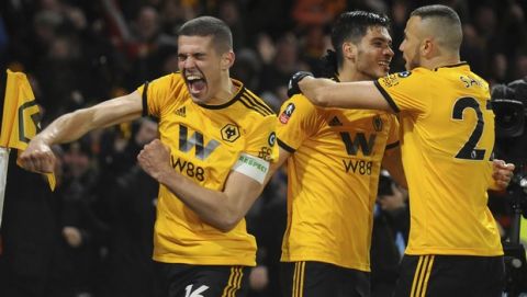 Wolverhampton's Raul Jimenez, centre, celebrates with teammates after scoring his side's opening goal during the English FA Cup Quarter Final soccer match between Wolverhampton Wanderers and Manchester United at the Molineux Stadium in Wolverhampton, England, Saturday, March 16, 2019. (AP Photo/Rui Vieira)