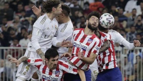 Atletico Madrid's players and Real Madrid's players jump for the ball during the Spanish Super Cup Final soccer match between Real Madrid and Atletico Madrid at King Abdullah stadium in Jiddah, Saudi Arabia, Sunday, Jan. 12, 2020. (AP Photo/Hassan Ammar)