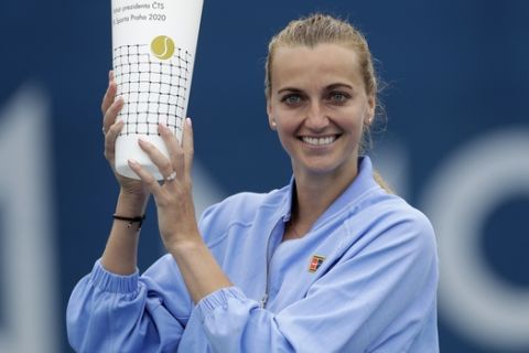 Petra Kvitova poses with a trophy after winning the Czech Tennis President's Cup charity tournament final match against Karolina Muchova in Prague, Czech Republic, Thursday, May 28, 2020.  The Czech government have taken further steps to ease its restrictive measures adopted to contain the coronavirus pandemic. (AP Photo/Petr David Josek)