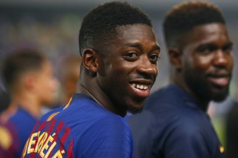 Barcelona's Ousmane Dembele and Samuel Umtiti, right, smile after winning the Spanish Super Cup soccer match between Sevilla and Barcelona in Tangier, Morocco, Sunday, Aug. 12, 2018. Barcelona won 2-1. (AP Photo/Mosa'ab Elshamy)