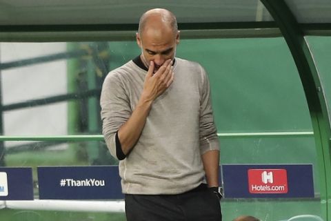 Manchester City's head coach Pep Guardiola reacts during the Champions League quarterfinal soccer match between Lyon and Manchester City at the Jose Alvalade stadium in Lisbon, Portugal, Saturday, Aug. 15, 2020. (Miguel A. Lopes/Pool via AP)