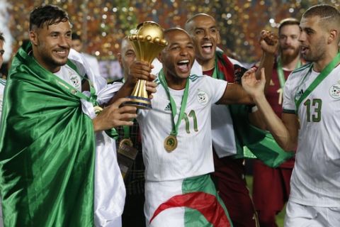 Algerian players celebrate after the African Cup of Nations final soccer match between Algeria and Senegal in Cairo International stadium in Cairo, Egypt, Friday, July 19, 2019. (AP Photo/Ariel Schalit)