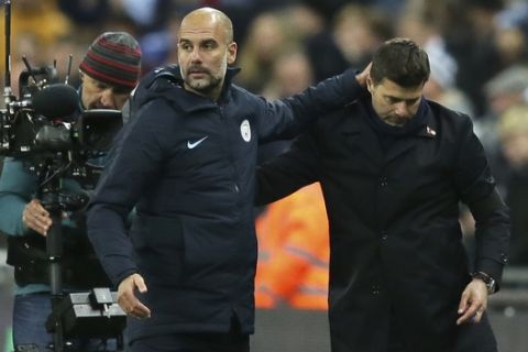 Manchester City coach Pep Guardiola and Tottenham manager Mauricio Pochettino, right, embrace each other at the end of the English Premier League soccer match between Tottenham Hotspur and Manchester City at Wembley stadium in London, England, Monday, Oct. 29, 2018. (AP Photo/Tim Ireland)