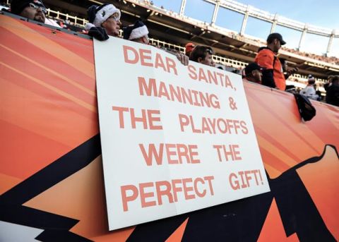 Dec 23 2012; Denver, CO, USA; Denver Broncos fans hold a sign in reference to  quarterback Peyton Manning (18) (not pictured) during the game against the Cleveland Browns at Sports Authority Field. The Broncos defeated the Browns 34-12. Mandatory Credit: Ron Chenoy-USA TODAY Sports