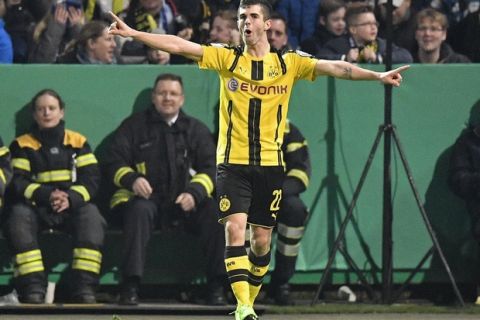 Dortmund's Christian Pulisic celebrates after scoring the opening goal during the German Soccer Cup quarterfinal match between SF Lotte and Borussia Dortmund in Osnabrueck, Germany, Tuesday, March 14, 2017. (AP Photo/Martin Meissner)