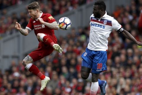 Stoke City's Mame Biram Diouf, right and Liverpool's Alberto Moreno battle for the ball, during the English Premier League soccer match between Liverpool and Stoke City, at Anfield, in Liverpool, England, Saturday April 28, 2018. (Martin Rickett/PA via AP)