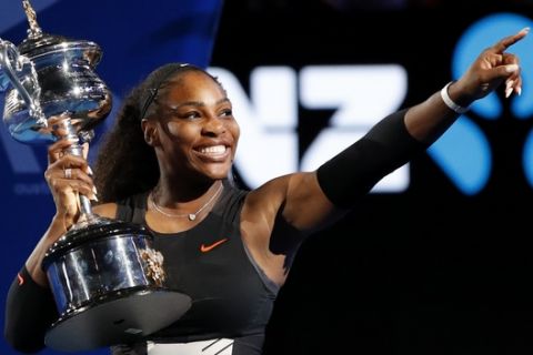United States' Serena Williams holds her trophy after defeating her sister Venus during the women's singles final at the Australian Open tennis championships in Melbourne, Australia, Saturday, Jan. 28, 2017. (AP Photo/Dita Alangkara)