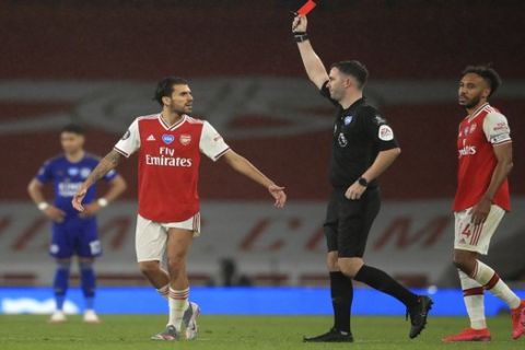 Referee Chris Kavangah shows a red card to Arsenal's Eddie Nketiah, not pictured, during the English Premier League soccer match between Arsenal and Leicester at Emirates Stadium in London, England, Tuesday, July 7, 2020. (AP Photo/Adam Davy,Pool)