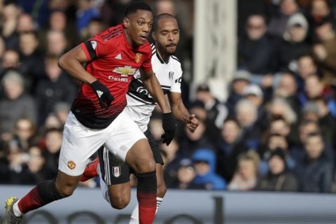 Manchester United's Anthony Martial, front, scores his side's second goal during the English Premier League soccer match between Fulham and Manchester United at Craven Cottage stadium in London, Saturday, Feb. 9, 2019. (AP Photo/Matt Dunham)