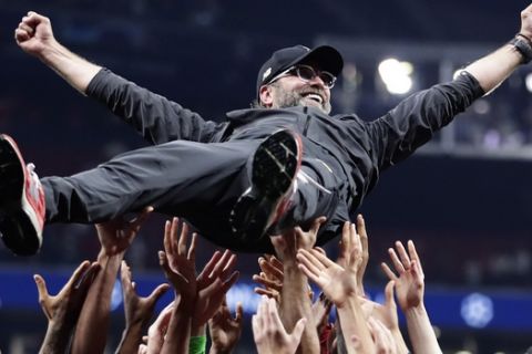 Liverpool coach Juergen Klopp is thrown into the air by player after winning the Champions League final soccer match between Tottenham Hotspur and Liverpool at the Wanda Metropolitano Stadium in Madrid, Saturday, June 1, 2019. (AP Photo/Manu Fernandez)