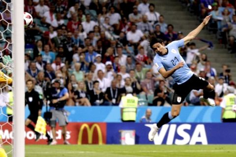 Uruguay's Edinson Cavani scores his side's opening goal during the round of 16 match between Uruguay and Portugal at the 2018 soccer World Cup at the Fisht Stadium in Sochi, Russia, Saturday, June 30, 2018. (AP Photo/Andrew Medichini)