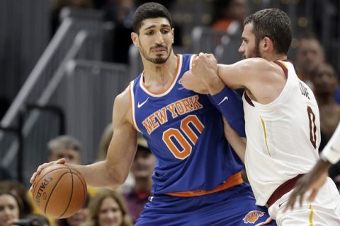 New York Knicks' Enes Kanter, left, drives past Cleveland Cavaliers' Kevin Love in the first half of an NBA basketball game, Sunday, Oct. 29, 2017, in Cleveland. (AP Photo/Tony Dejak)